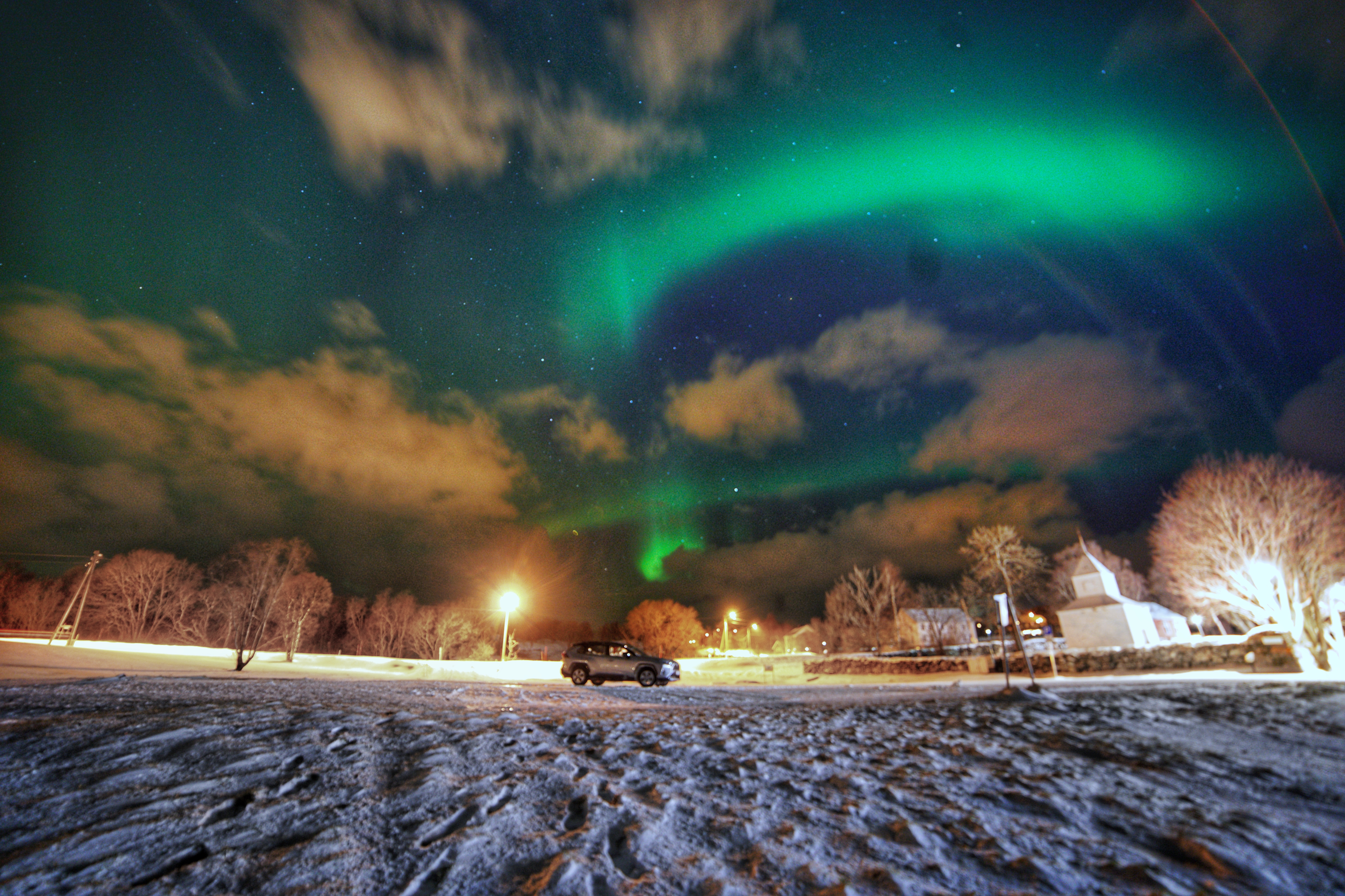 northern lights aurora borealis harstad trondenes medieval stone church norway toyota rav 4