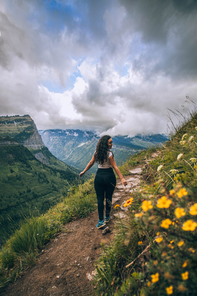 girl hiking on highline trail in glacier national park