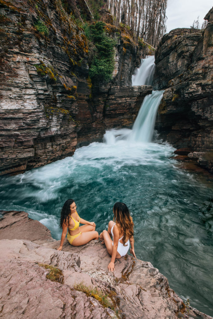 two girls enjoying st marys falls at glacier national park